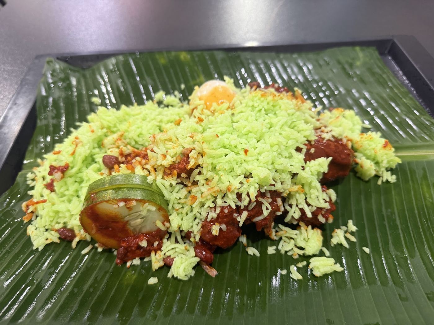 Green biryani rice on banana leaf
