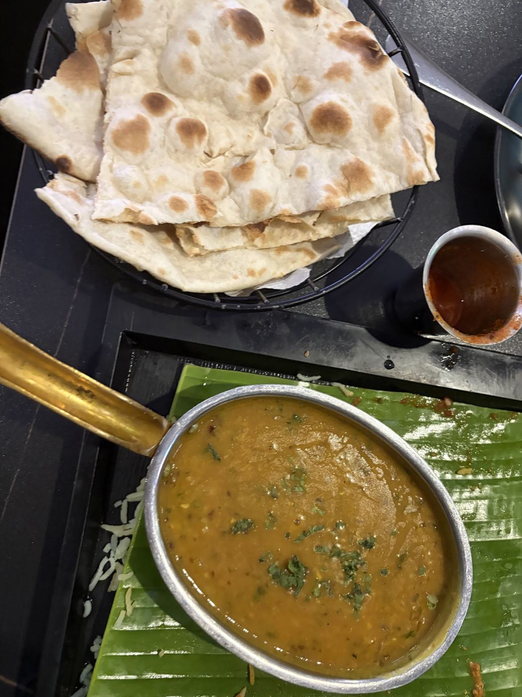 Naan and dal on banana leaf