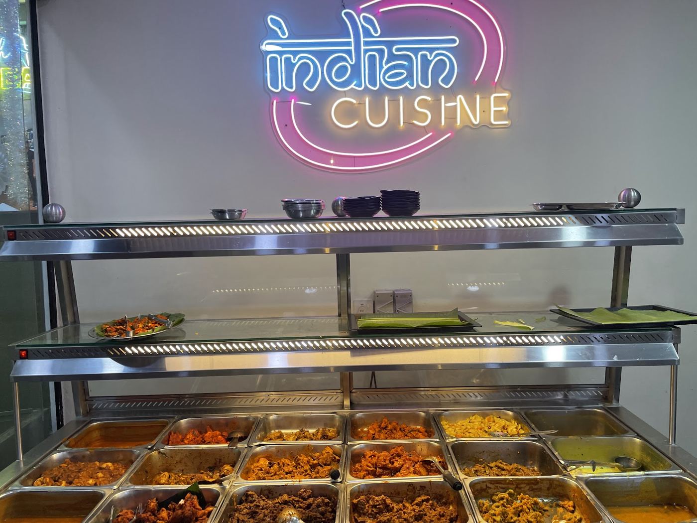 Indian Cuisine neon sign and food counter